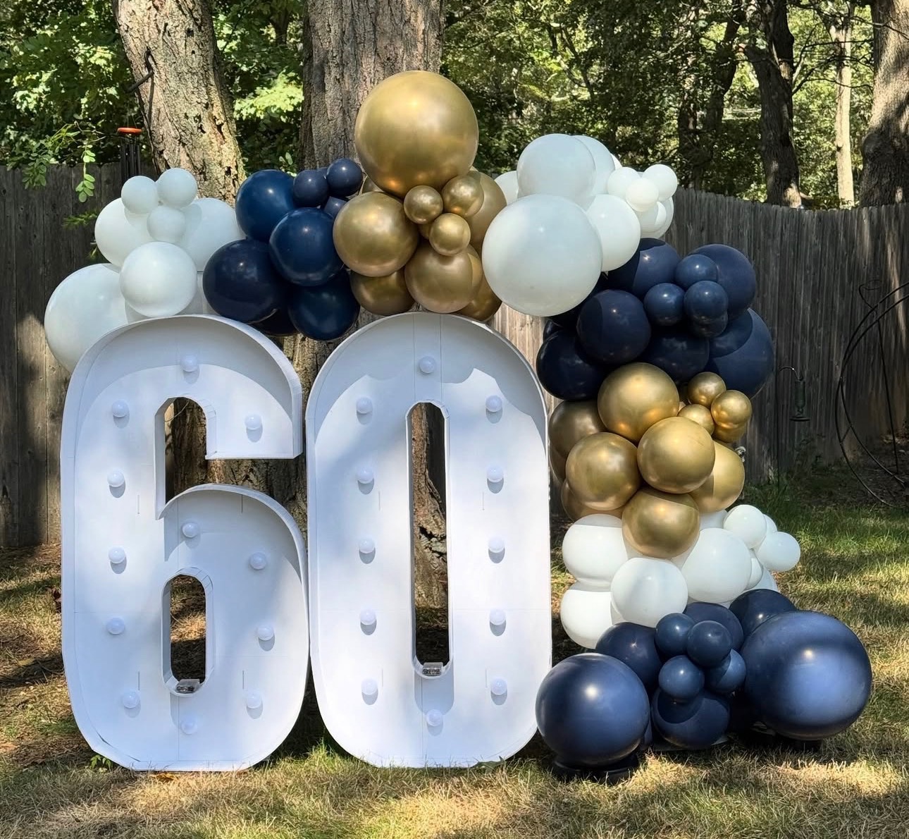 Navy, white and gold balloon garland with marquee 60 numbers